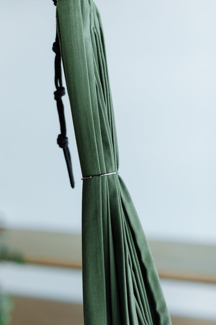 Detailed close-up of a tied green hammock, showcasing texture and color.